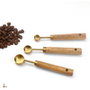 measuring spoon with wooden handle