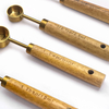 measuring spoon with wooden handle