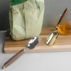 Stainless steel spoon with wooden handle