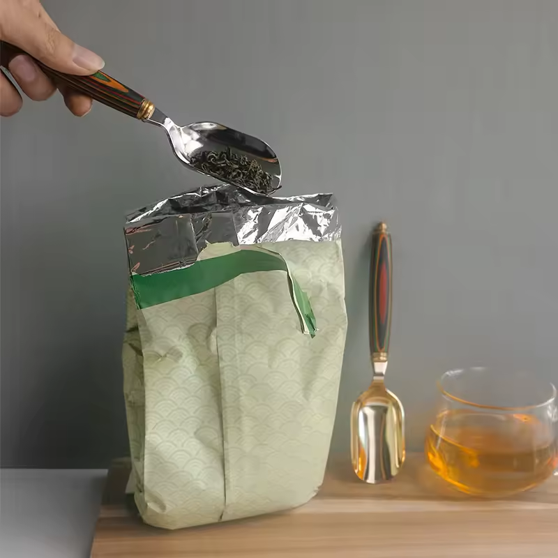 Stainless steel spoon with wooden handle